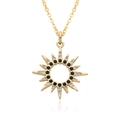Detail of gold starburst pendant necklace with black and white crystal inlay - Starburst Sun Style (c494)