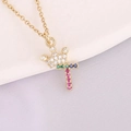Close-up of golden crown and multicolor zircon letter T pendant on chain - Letter T Style