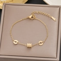 Elegant gold-tone stainless steel bracelet featuring roman numeral rings and a slider bead - Gold Roman Numeral Ring Style (5189)