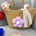 Detailed close-up of a cute purple plush flower keychain hanging on a straw bag - 1 Piece / Taro Purple