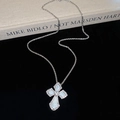 Detail of silver cross pendant with mother of pearl and rhinestones on black velvet - Silver Mother of Pearl Style
