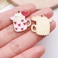 Close-up of pink enamel coffee cup cat charms with waffle texture on the back - Pink Cup White Cat - Vertical