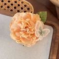 Apricot fabric flower hair claw with green leaf and embroidered butterfly detail - Champagne Flowers