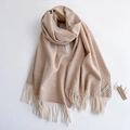 Soft beige cashmere-feel scarf with fringe tassels shown on a plain white background - Oatmeal
