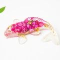 Resin goldfish ornament with pink dried flowers and gold foil accents on white background - Rose Red Koi