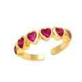 Detail of gold-plated ring with heart-shaped red cubic zirconia in a row setting - Adjustable Open / Rose Red