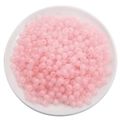 Loose pink frosted acrylic beads in a white bowl for DIY jewelry and crafts making - Frosted Pink Round Beads