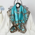 Blue silk scarf with gold chains and leopard print draped over a white shirt - Peacock Blue Chain