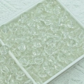 Macro shot of transparent spherical glass beads in a white organizer for DIY jewelry - White Jelly Beads (6mm)