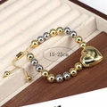 Adjustable 15-25cm beaded bracelet featuring gold heart pendant on beige velvet - Gold