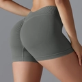 Detailed back view of high-waisted seamless scrunch butt yoga shorts in dark grey - S / Dark Gray
