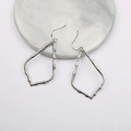 Detail view of silver water drop earrings with irregular geometric textured finish - Silver