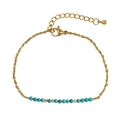 Gold stainless steel bracelet featuring turquoise beads and faceted metal accents - Turquoise