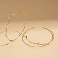 Detailed close-up of golden geometric hoop earrings with triangle stud accents in warm lighting - Gold Color Rivet Hoop with Silver Pin / Gold