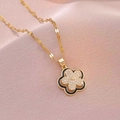 Golden rotating flower necklace with black enamel petals and sparkling zircon center - X3419 Rotating Flower