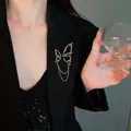 Chic butterfly chain brooch with textured metal on elegant black suit jacket for women - Pleated Rhinestone Butterfly Chain Style
