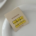 Detail showing three yellow bone-shaped hair clips with matte finish on a card - Dark Yellow (Set of 3)