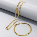 Polished gold-tone Miami Cuban link chain necklace and bracelet set on geometric stands - 4mm Gold / Bracelet 20CM