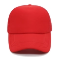 Close-up of red mesh trucker hat with breathable polyester back and curved brim - Red