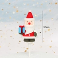 Detailed view of a 5.5cm Santa Claus cake topper holding a blue gift box decoration - Soft Glue Santa with Gift Box