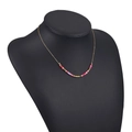 Bohemian gold chain necklace with colorful disc beads on a black display stand - Red Pink Multi-Color Mixed Beads