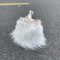 Top view of white faux sheep fur bucket bag with drawstring closure on asphalt background - Pure White