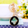 Chic gold metal keychain with black clover charm and sparkling rhinestone butterfly - Black Luxury Clover