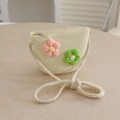 Detail of beige straw crossbody bag with crochet flower accents and zipper closure - Bag-Creamy White