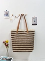Detail of raffia woven tote bag with brown and white stripes hanging on a wooden wall hook - Coffee Striped