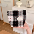 Close-up of vintage red and black plaid tweed fabric makeup bag with brand label - Black & White Small