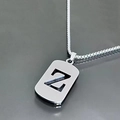 Macro shot of a silver letter Z pendant on a sleek titanium steel chain necklace - Letter Z