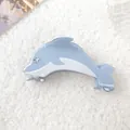 Elegant blue dolphin acetate hair claw clip with star detail on soft plush background - Blue Dolphin
