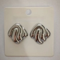 Abstract wave-shaped earrings in polished silver finish on a display card - Square Swirl / Steel