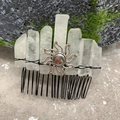 Macro detail of natural quartz crystals and sun emblem hand-wrapped on a metal hair comb - Clear Quartz Black Wire Silver Sun
