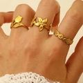Three-piece set of golden floral rings featuring tulip and daisy motifs on female fingers - Flower 3-Piece Set