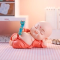 Sleeping little monk resin figurine in red robe holding a blue scepter for desk decor - Lying Buddha Pose (Large Red)