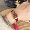 Luxury gold watch for women with snake-shaped dial and red leather strap on wrist - Gold/Red (Irregular Snake Head Shape)