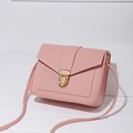 Pink synthetic leather crossbody bag with decorative white stitching and gold metal buckle - Pink