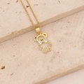 Macro view of gold plated bear pendant necklace with sparkling cubic zirconia on stone base - Bowknot Clear Stone Bear (12#)