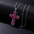 Silver cross pendant necklace featuring five faceted deep pink crystals on a metal chain - Rose Red Cross