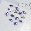 Detailed view of scattered purple K9 crystal rhinestones and gold decorative stones - Small Axe 6x10mm