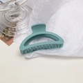 Close-up of a matte sage green hair claw clip on white textured paper background - Semi-circle / Milky Blue