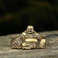 Miniature brass Maitreya Buddha statue with gold ingot on a natural stone background - Maitreya Buddha