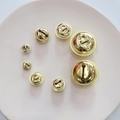 Polished gold metal bells in various sizes on a decorative plate for DIY crafts - 1.1cm / Gold