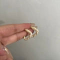 Vintage gold and cream enamel C-shaped twist hoop earrings for women shown on hand - Two-tone Twisted Rope C-hoop