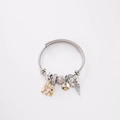 Detailed shot of stainless steel twisted bracelet with elephant and feather charms - Pink