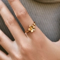 Close-up of a gold five-petal flower ring on a model hand with elegant metal texture - Adjustable Open / Exquisite Five-Petal Small Flower (KR0104)
