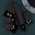 Elegant matte black drawer jewelry gift boxes set on dark textured fabric background - Black Cardboard Color