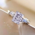 Macro shot of silver wedding ring with large rectangular center stone and side diamonds - US 5 / White