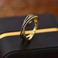 Crossed golden metal ring featuring micro-pave set deep blue zircons for men and women - US Size 9 / Gold Color - Blue Zirconia